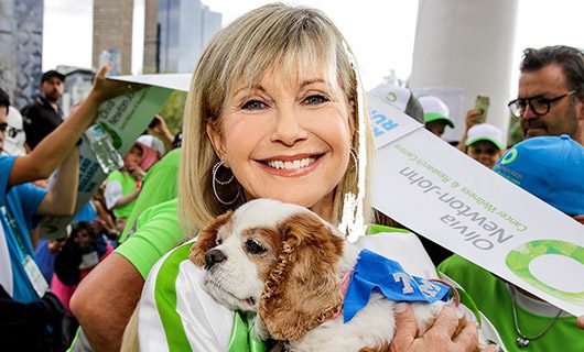 Image of Olivia Newton-John and here dog in a crowd supporting Walk for Wellness